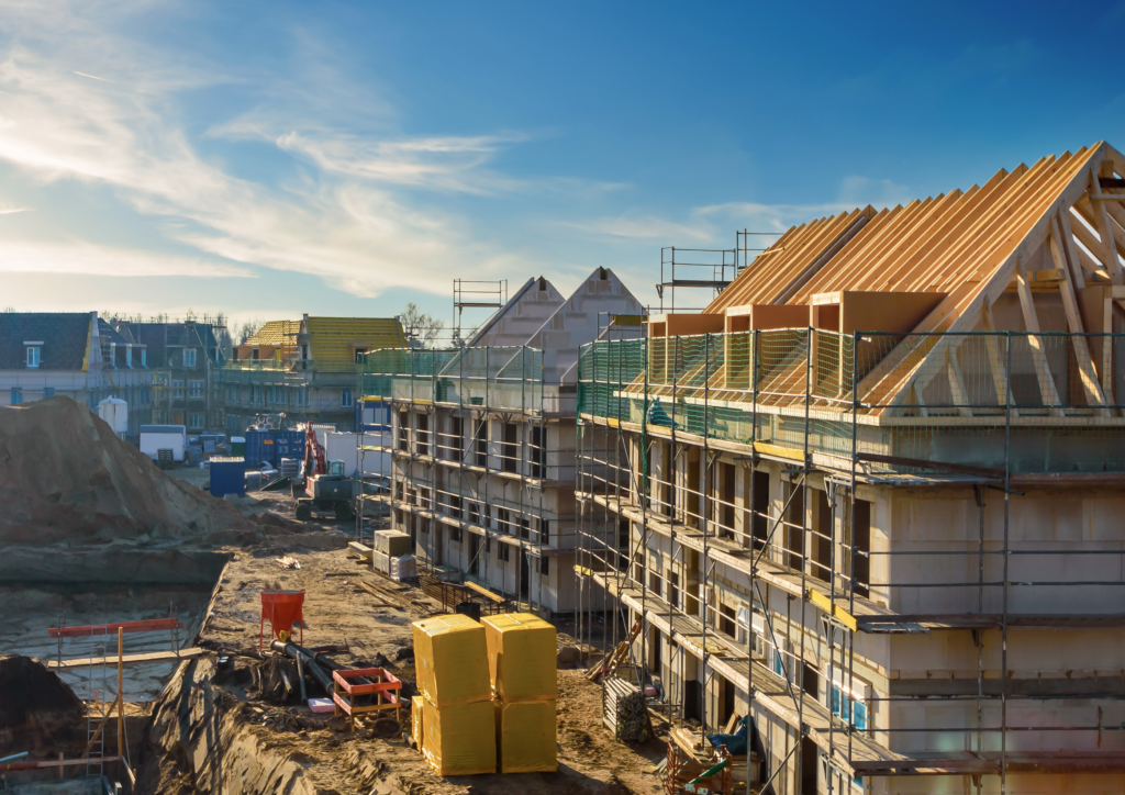 new build homes being built on a sunny day surrounded by blue skies and lots of scaffolding